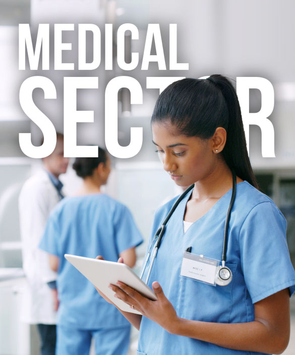 A medical professional wearing scrubs and a stethoscope is focused on a digital tablet. The background features two other healthcare workers in a clinical setting. The text "MEDICAL SECTOR" is prominently displayed in large white letters, evoking the dedication seen in an NHS promotional video.