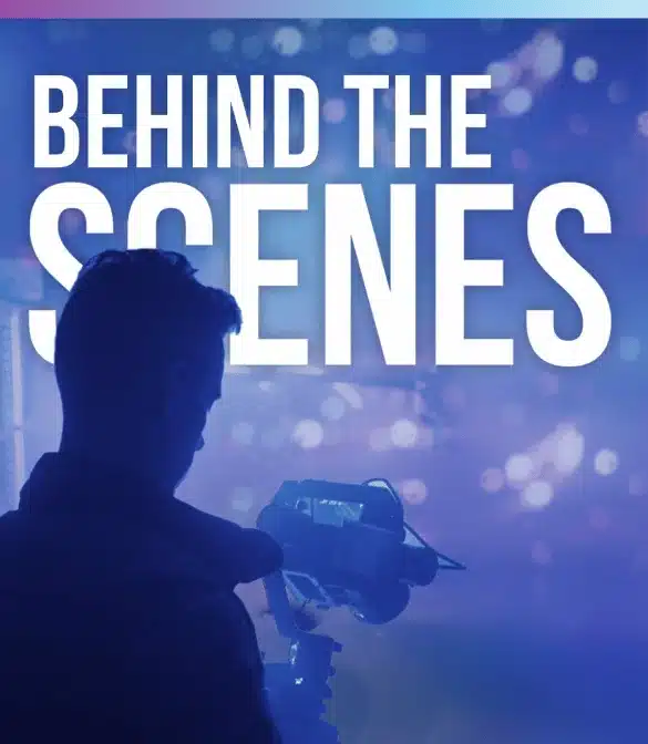 Silhouette of a person operating a camera with a blurred background of blue and purple hues. Large white text at the top reads 'BEHIND THE SCENES.' Perfectly capturing the essence of video advertising.