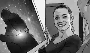 A woman with a ponytail holds a framed picture of two bears hugging against a starry night sky, smiling warmly. It's as if she's starring in a heartfelt video advertising campaign, standing next to another person whose face is not visible.