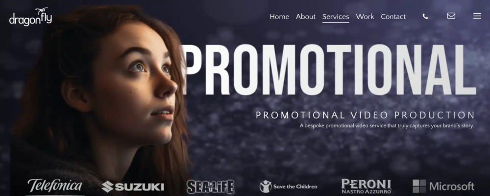 A Young Woman Gazes Upwards Contemplatively Against A Dark, Starry Backdrop. Text Reads: &Quot;Promotional Video Production. A Bespoke Service That Truly Captures Your Brand'S Story.&Quot; Featured Logos Include Telefónica, Suzuki, Microsoft, Etc. As One Of The Top 10 Video Production Companies, We Offer Home, About, Services, Work, And Contact Options. The Dragonfly Logo Is A young woman gazes upwards contemplatively against a dark, starry backdrop. Text reads: "PROMOTIONAL VIDEO PRODUCTION. A bespoke service that truly captures your brand's story." Featured logos include Telefónica, Suzuki, Microsoft, etc. As one of the Top 10 Video Production Companies, we offer Home, About, Services, Work, and Contact options. The Dragonfly logo is